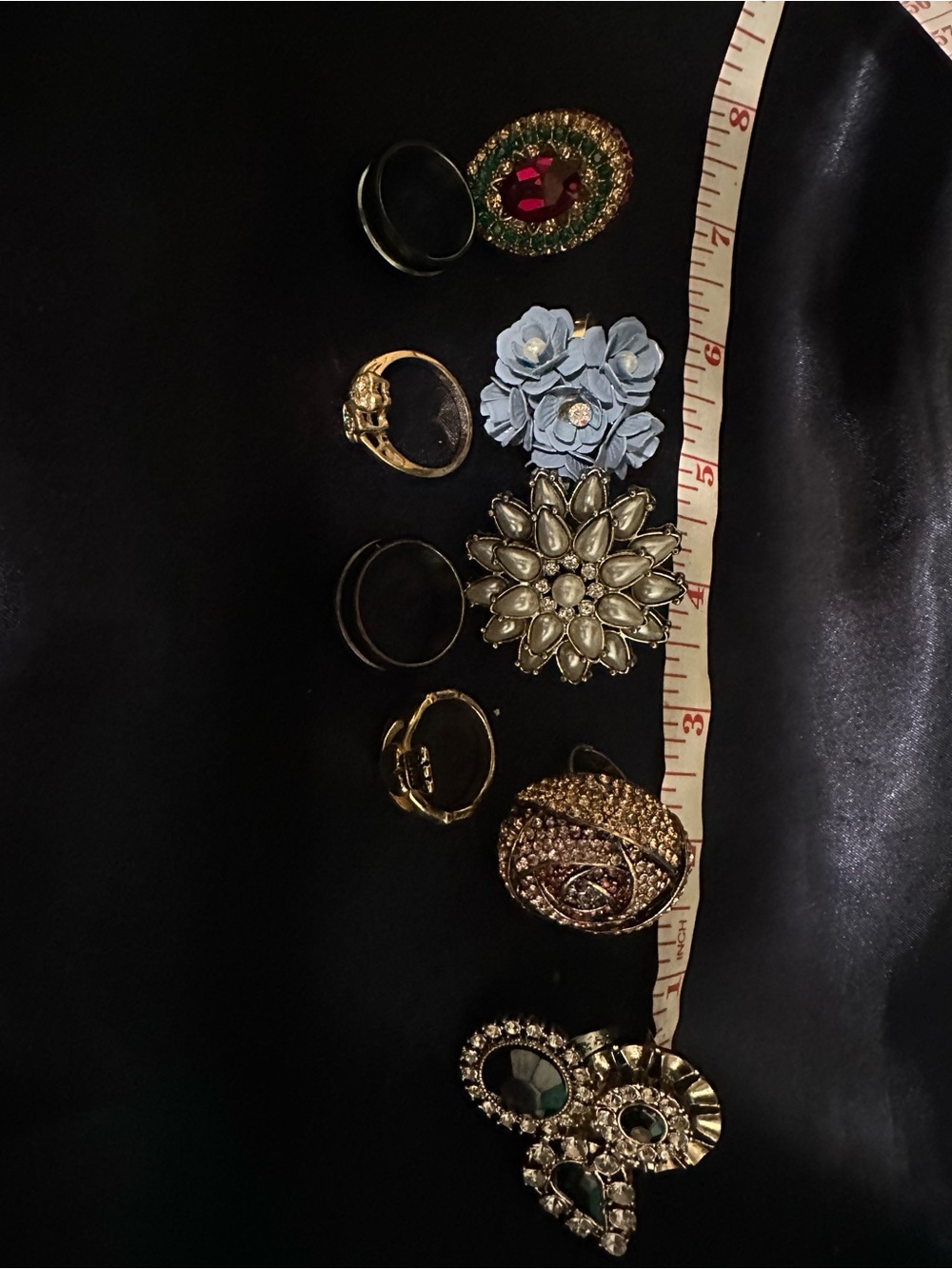 9 assorted statement and cocktail and plain band rings.